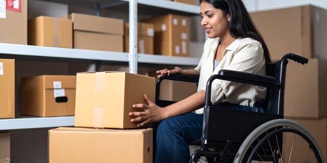 accesibilidad-trasteros en tamaño mediano Persona en silla de ruedas, con mobilidad reducida, coloca cajas en un trastero de alquiler